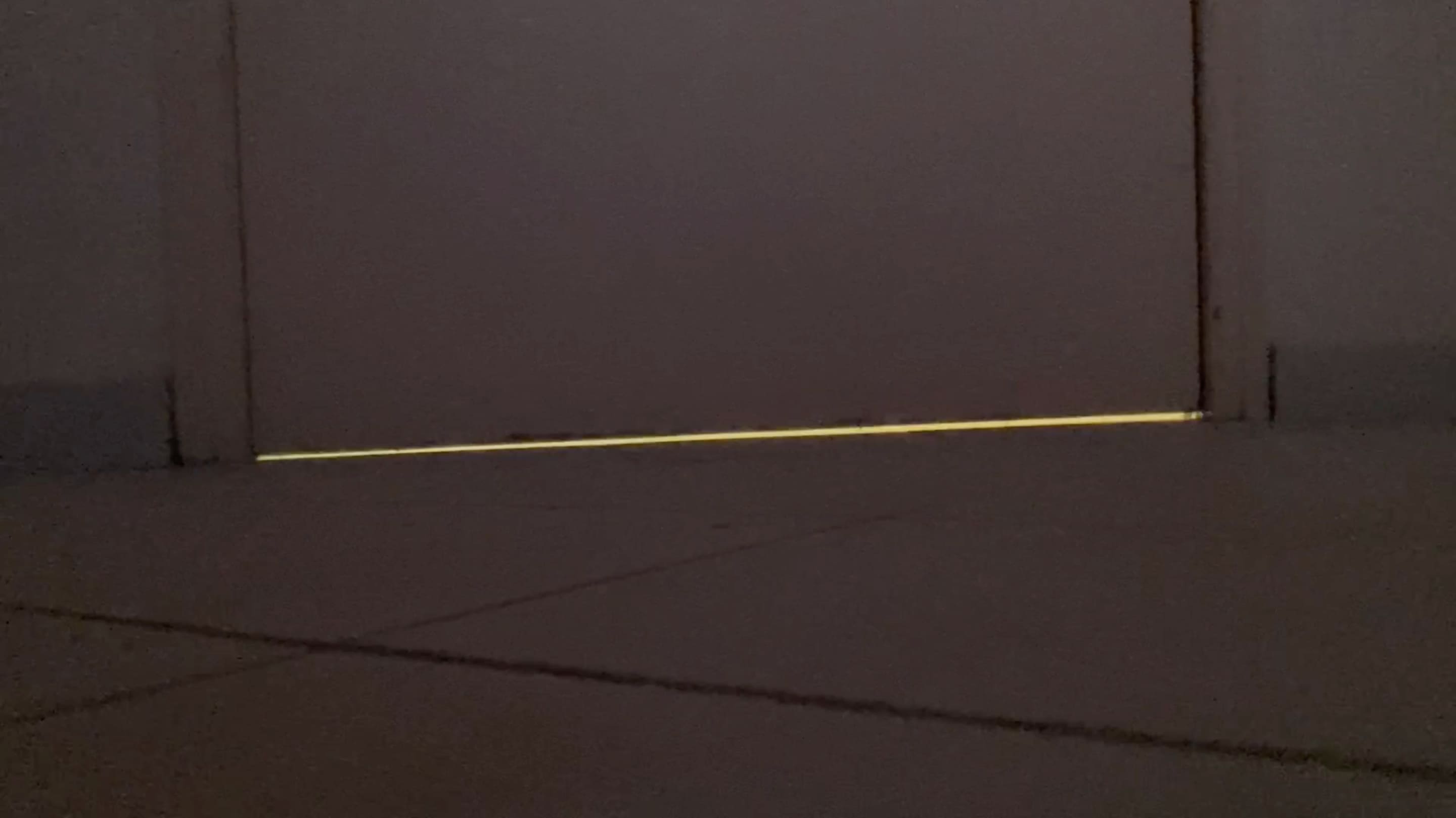 2e photographie d'Eye of the Creator où on voit à travers le bas d'une porte que la lumière de la pièce d'en face est allumée.